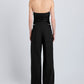 A person stands with their back to the camera, wearing a black strapless top and Proenza Schouler White Label Coralie Pant—high-waisted with a wide-leg silhouette—against a plain light background.