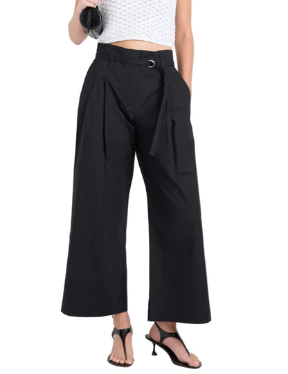 A person wearing Proenza Schouler White Label Cropped Raver Pant, a white sleeveless top, and black open-toe heels stands with one hand in their pocket.