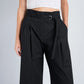 Model wears Proenza Schouler White Label Cropped Raver Pant in high-rise black with belt detail and a white crochet sleeveless crop top, posed against a plain background.