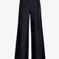 The Lina Pant by Proenza Schouler White Label is a high-waisted, wide-leg black denim style featuring front patch pockets and an adjustable fabric belt with a metal ring buckle.