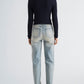 Back view of a person wearing a dark navy textured Proenza Schouler White Label Marci Cardigan with a crew neckline and long sleeves, paired with light-wash blue jeans.