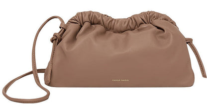 A Mansur Gavriel Mini Cloud Clutch with a multi-function shoulder strap and a subtle Mansur Gavriel logo on the front.