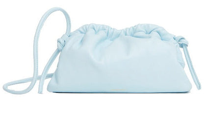 A light blue, soft leather Mansur Gavriel Mini Cloud Clutch made from Italian lamb leather, featuring a drawstring closure and a multi-function strap.