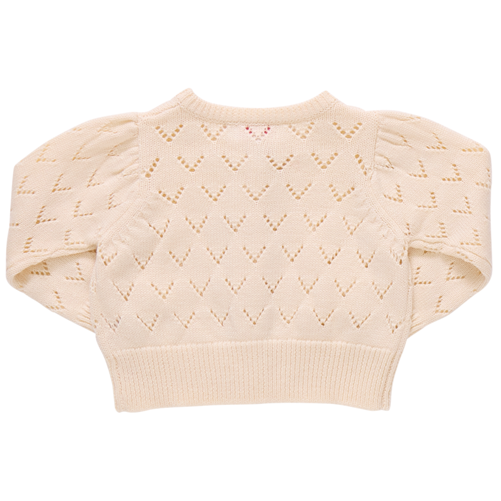 The Girls' Connie Sweater by Pink Chicken features a cream chevron eyelet pattern and puffed sleeves. Shown from the back on a white background, this pointelle cardigan adds delicate texture to any girl's wardrobe.