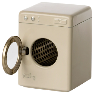 A beige Maileg Washing Machine, Mouse from Maileg, resembling a toy appliance, stands with its front-loading door open.