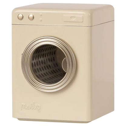 The "Maileg Washing Machine, Miniature" by Maileg is a beige front-loading washing machine featuring a round, transparent door and metal control knobs on the top left.