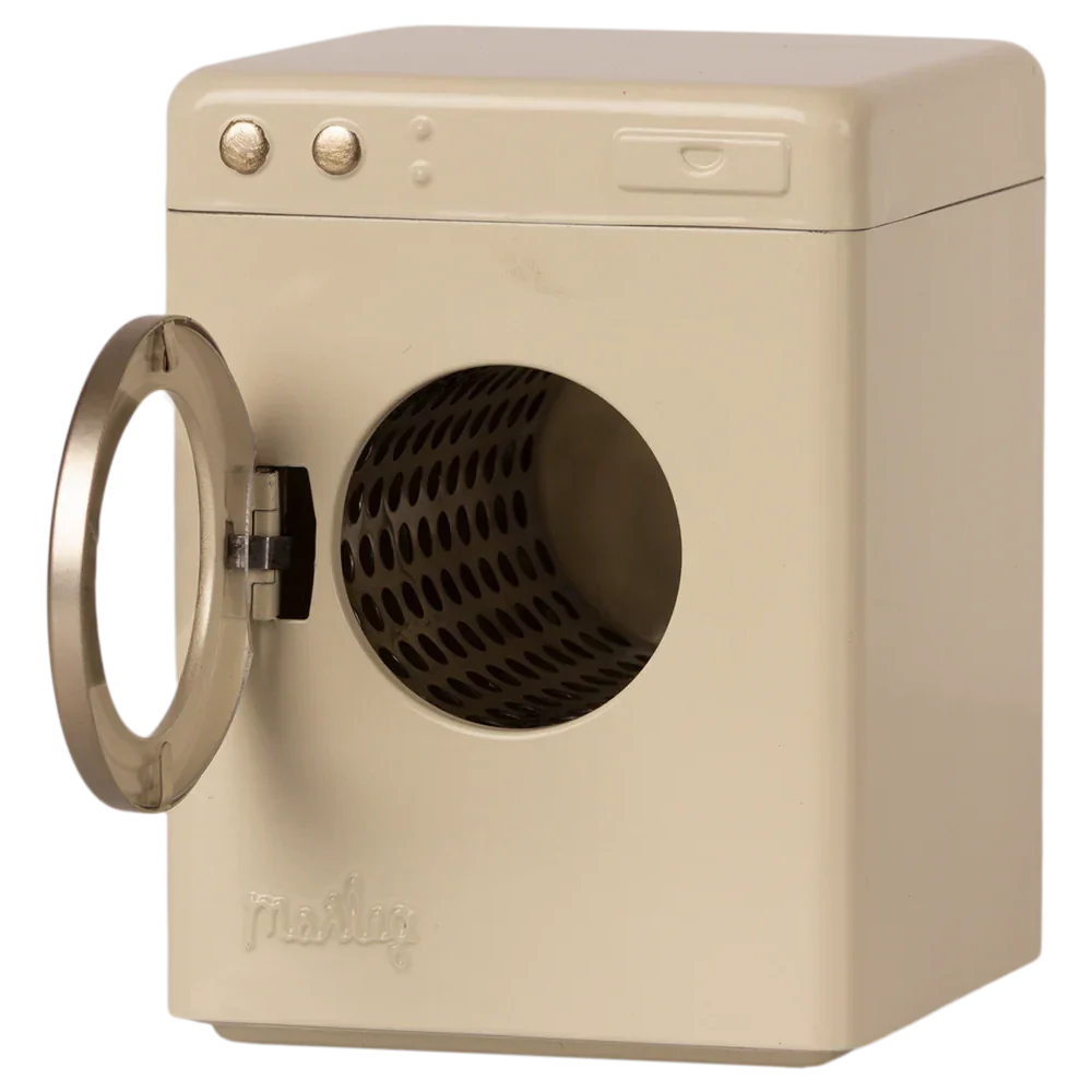 A beige, front-loading Maileg Washing Machine, Miniature with its door open reveals the empty drum inside. The metal machine, from the renowned brand Maileg, features two control knobs on the top left corner, ready to tackle your laundry needs.