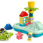 The LEGO® DUPLO® Water Park by Legos - Toyhouse is a vibrant toy set that includes stackable blocks to form a house and palm tree on a blue base, a green floaty with a child figure, a pink starfish, and an additional child figure—ideal for designing your own bath toy water park.