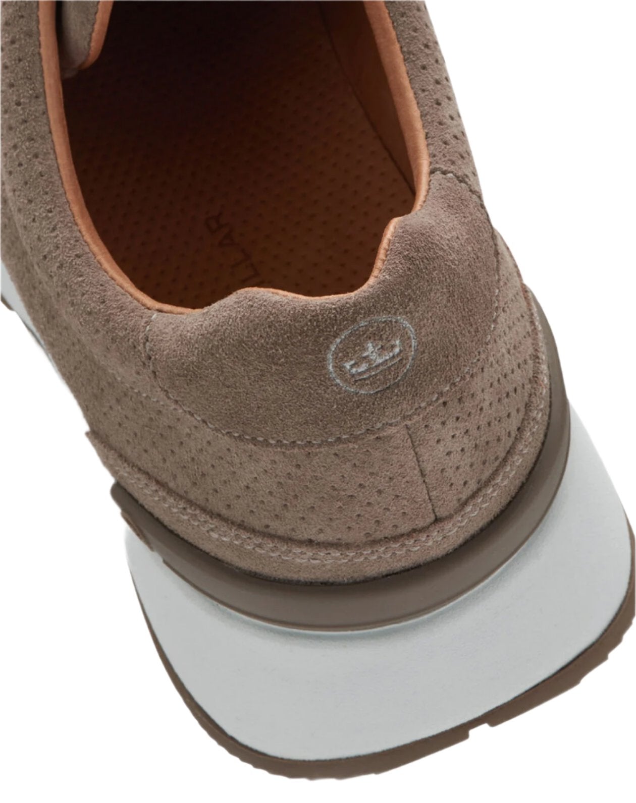 A close-up of the Peter Millar Wayfare Runner showcases a tan suede sneaker with a perforated design, white EVA midsole, and brown liner. The Peter Millar logo is embossed on the heel, capturing the essence of vintage runners.