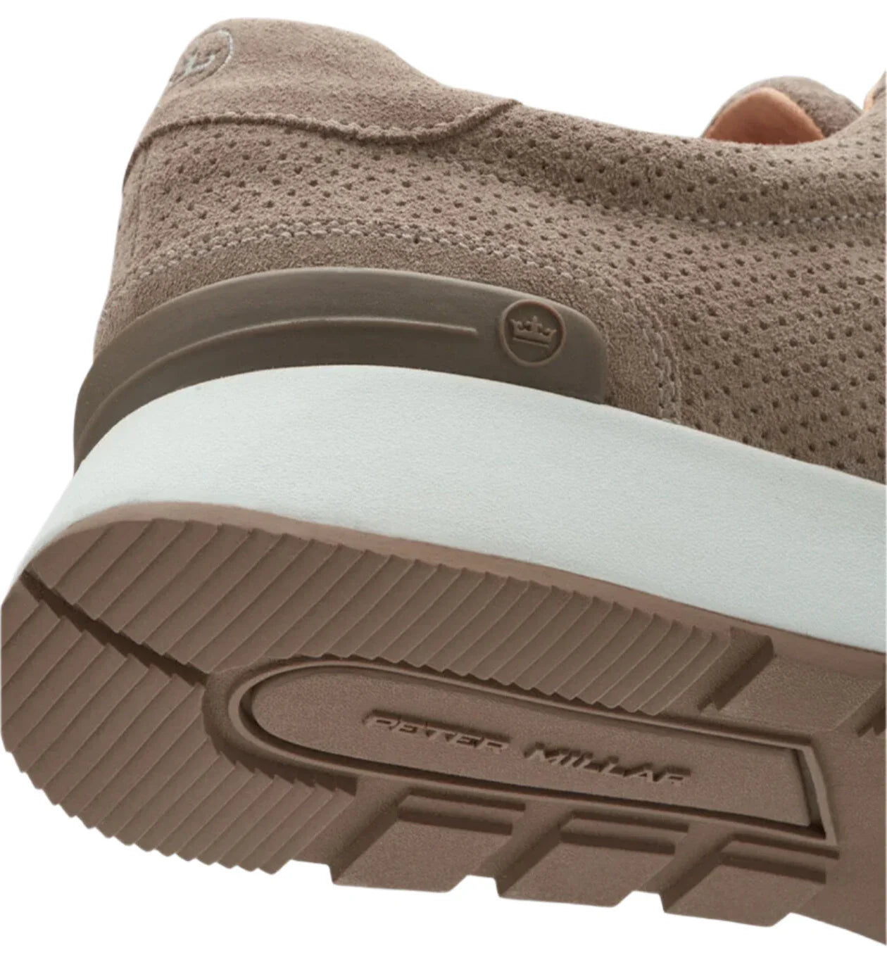 Close-up of the sole of a beige Peter Millar Wayfare Runner sneaker, featuring the Peter Millar brand name imprint and a textured surface, complemented by an EVA midsole that evokes the style of classic vintage runners.