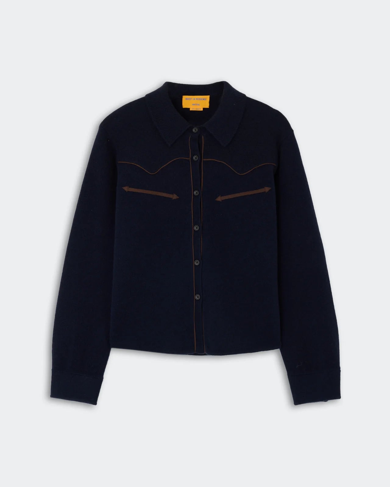 Cropped Western Shirt by Guest in Residence in dark navy cashmere, featuring a collar, brown piping on the chest, long sleeves, and a straight hem, displayed against a light background.