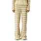 Only the lower body is visible, featuring the Western Stripe Pant by Guest in Residence styled with a matching fringe top.
