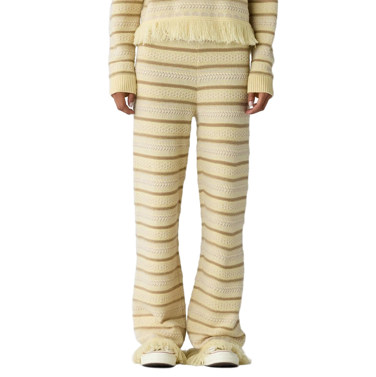 Only the lower body is visible, featuring the Western Stripe Pant by Guest in Residence styled with a matching fringe top.