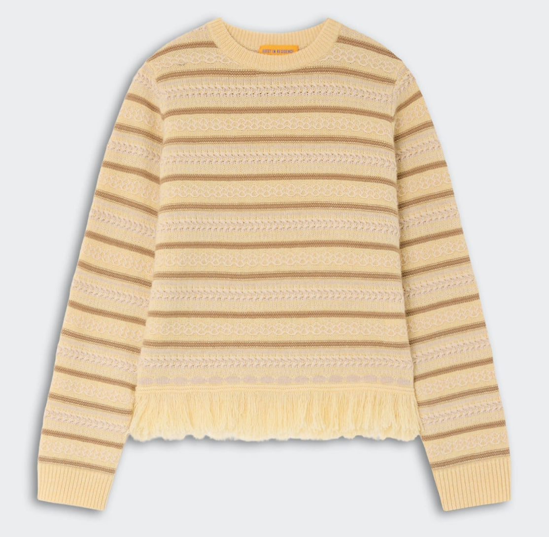 The Western Stripe Crew by Guest in Residence features long sleeves, beige and yellow stripes, textured patterns, and a chic fringed hem.