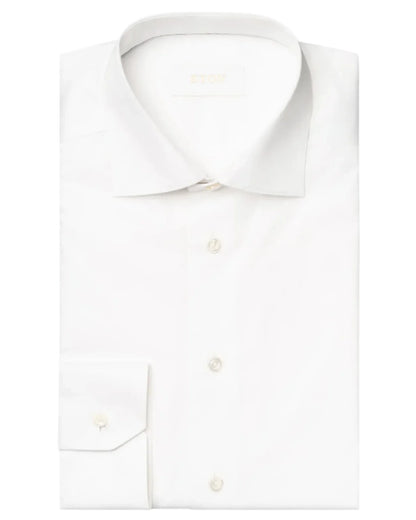 The Eton Solid Elevated Twill Shirt, crafted from crease-resistant organic cotton, boasts a neatly folded design with a classic collar and buttoned cuffs.