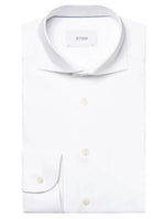 A neatly folded Eton White Four-Flex Shirt, Contemporary Fit with a tag reading "Eton" inside the collar, boasting a refined four-way stretch for ultimate comfort.