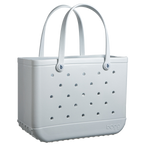 A light gray, rectangular Original Bogg Bag by Bogg Bags beach tote with perforated holes and sturdy handles. The bag boasts a textured bottom for durability, and its washable design ensures easy cleaning.