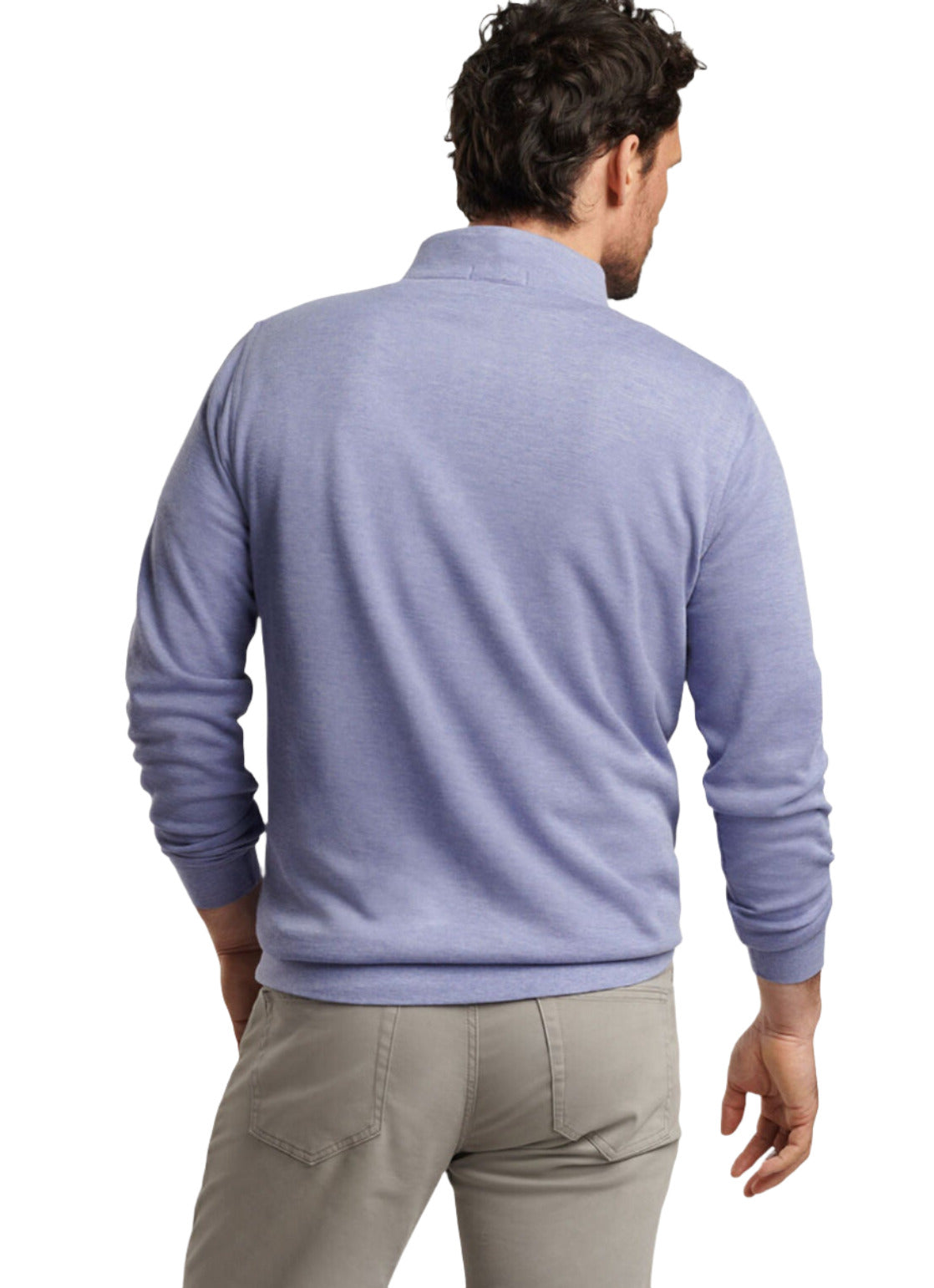 A man wearing the Peter Millar Crown Comfort Pullover in light blue and beige pants, standing with his back to the camera.