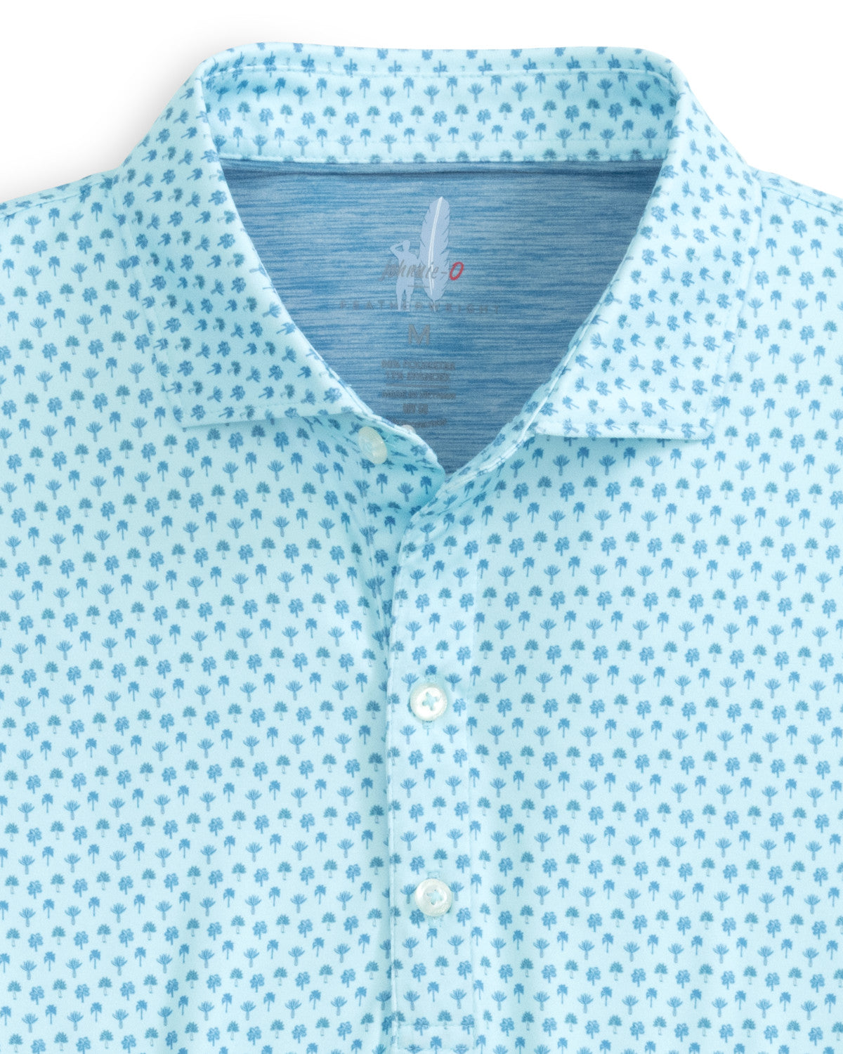 Introducing the Johnnie-O Woods Polo, a part of our Featherweight Collection. This polo shirt by Johnnie-O showcases a subtle light blue tree pattern, complemented by a classic collar and three-button design. It is designed with moisture-wicking properties and UPF 50 sun protection for both style and comfort in the sun.