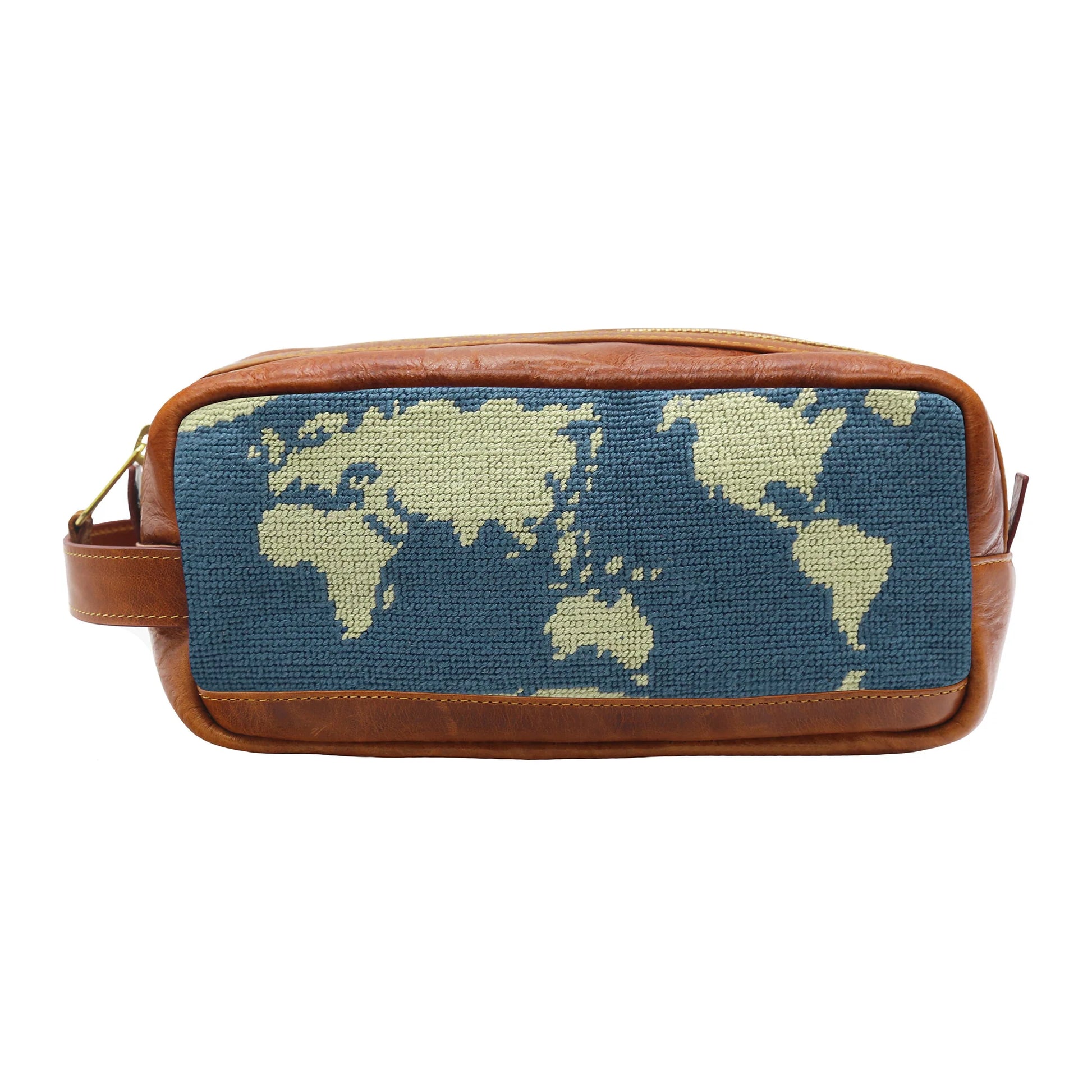 The Smathers & Branson Toiletry Bag is a rectangular brown Italian leather pouch with a woven fabric front panel, showcasing a beige world map against a blue background. Its hand-stitched needlepoint design gives it an artisanal feel, making this bag both stylish and functional.