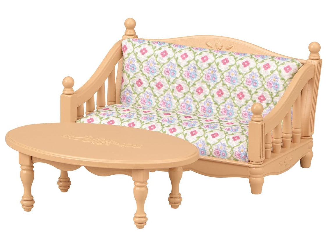 A petite light-wood sofa with a patterned cushion and a coordinating oval coffee table, ideal for a Calico Critters Chocolate Rabbit girl to unwind in her Calico Critters Red Roof Cozy Cottage.