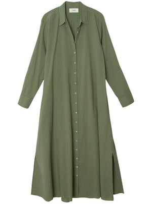 The Xirena Boden Dress by Xirena is a tailored olive green shirtdress featuring long sleeves, a collar, and a button-down front. Crafted from Cotton Poplin, this dress includes side slits at the hem.