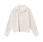 The Wyler Shirt by Xirena is a soft cotton, boxy-fit button-front shirt with long sleeves, a collar, a left chest pocket, and vertical black stripes on a white background.