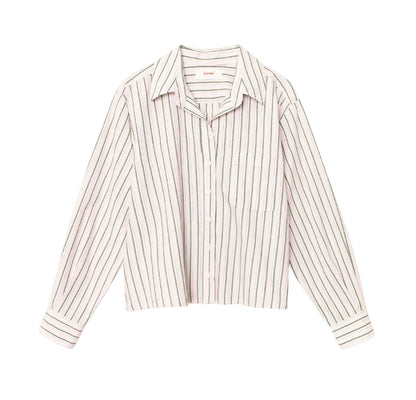The Wyler Shirt by Xirena is a soft cotton, boxy-fit button-front shirt with long sleeves, a collar, a left chest pocket, and vertical black stripes on a white background.