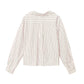 The Wyler Shirt by Xirena is a long-sleeve, white cotton button-up with vertical black stripes. Shown from the back, it features a collar, upper back pleat detailing, and a modern boxy fit for relaxed style.
