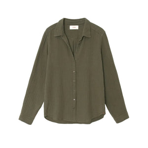 The Xirena Scout Cotton Gauze Shirt, shown on a plain white background, features an olive green hue, long sleeves, a button-up front with a collar, and a shirttail hem. It's crafted from textured washed cotton gauze fabric.