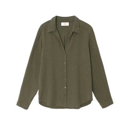 The Xirena Scout Cotton Gauze Shirt, shown on a plain white background, features an olive green hue, long sleeves, a button-up front with a collar, and a shirttail hem. It's crafted from textured washed cotton gauze fabric.