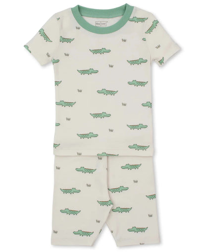 The Kissy Kissy Baby Boys’ and Boys’ Crocodile Walk SS Pajama Set is a cream, short-sleeved Pima cotton pajama with green trim and a playful small green crocodile print.