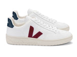 A pair of Veja Men's V-12 Leather Sneakers with maroon "V" logos on the side, dark blue heel tabs, and crafted from recycled materials.