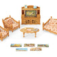 The Calico Critters Comfy Living Room Set includes two sofas, an armchair, a coffee table, an entertainment center, a TV, and four small picture cards arranged on a white background—ideal miniature furniture for dollhouses and imaginative play.