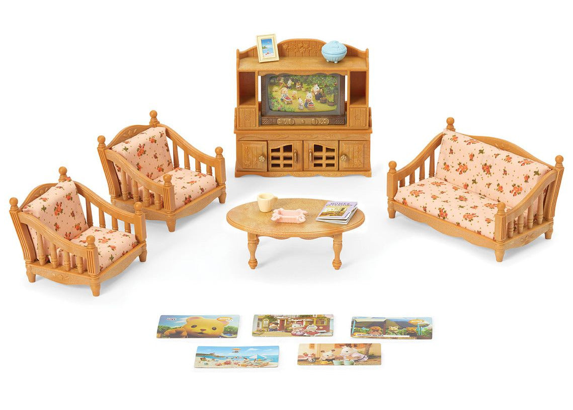 The Calico Critters Comfy Living Room Set includes two sofas, an armchair, a coffee table, an entertainment center, a TV, and four small picture cards arranged on a white background—ideal miniature furniture for dollhouses and imaginative play.