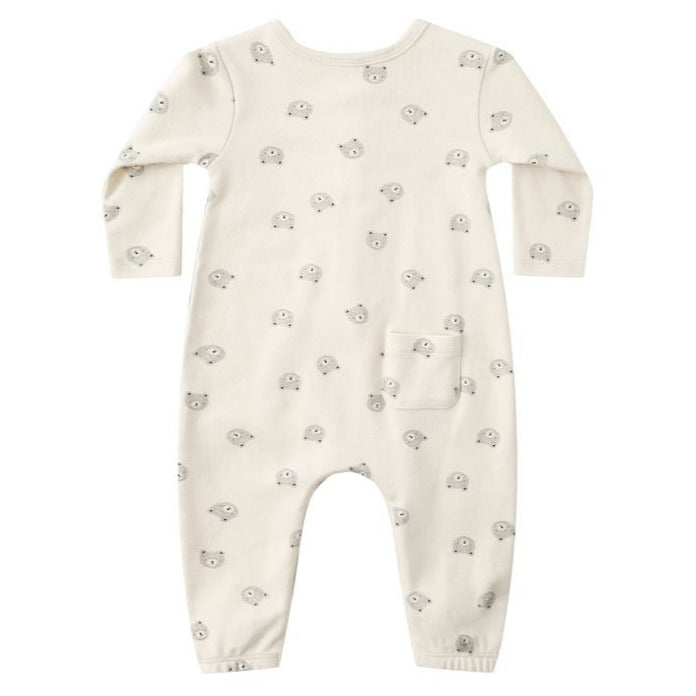The Quincy Mae Baby Long Sleeve Jumpsuit in cream features a bear face print, a small front pocket, and coconut buttons, shown on a white background.