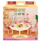 Four Calico Critters figures gather around a table filled with treats and drinks in a charming dollhouse scene, surrounded by vibrant furniture—perfect for imaginative play. The Calico Critters Sweets Party Set is recommended for ages 3 and up.