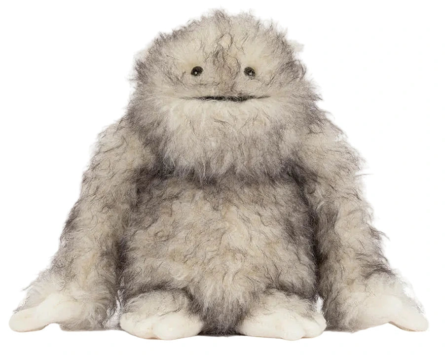 The Jellycat Bretti Yeti plush toy features shaggy gray fur, small black eyes, and large white hands and feet, sitting upright against a white background.