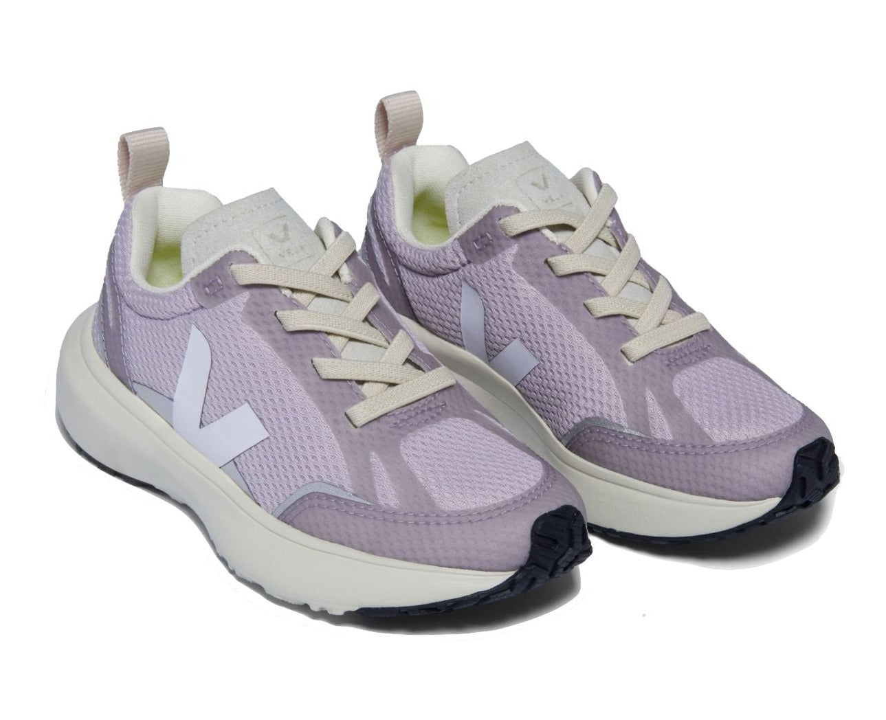 The Veja Junior Canary Alveomesh Sneaker from Veja is a pair of light purple sneakers with white laces and soles, featuring a white "V" logo on the sides, crafted from recycled polyester.