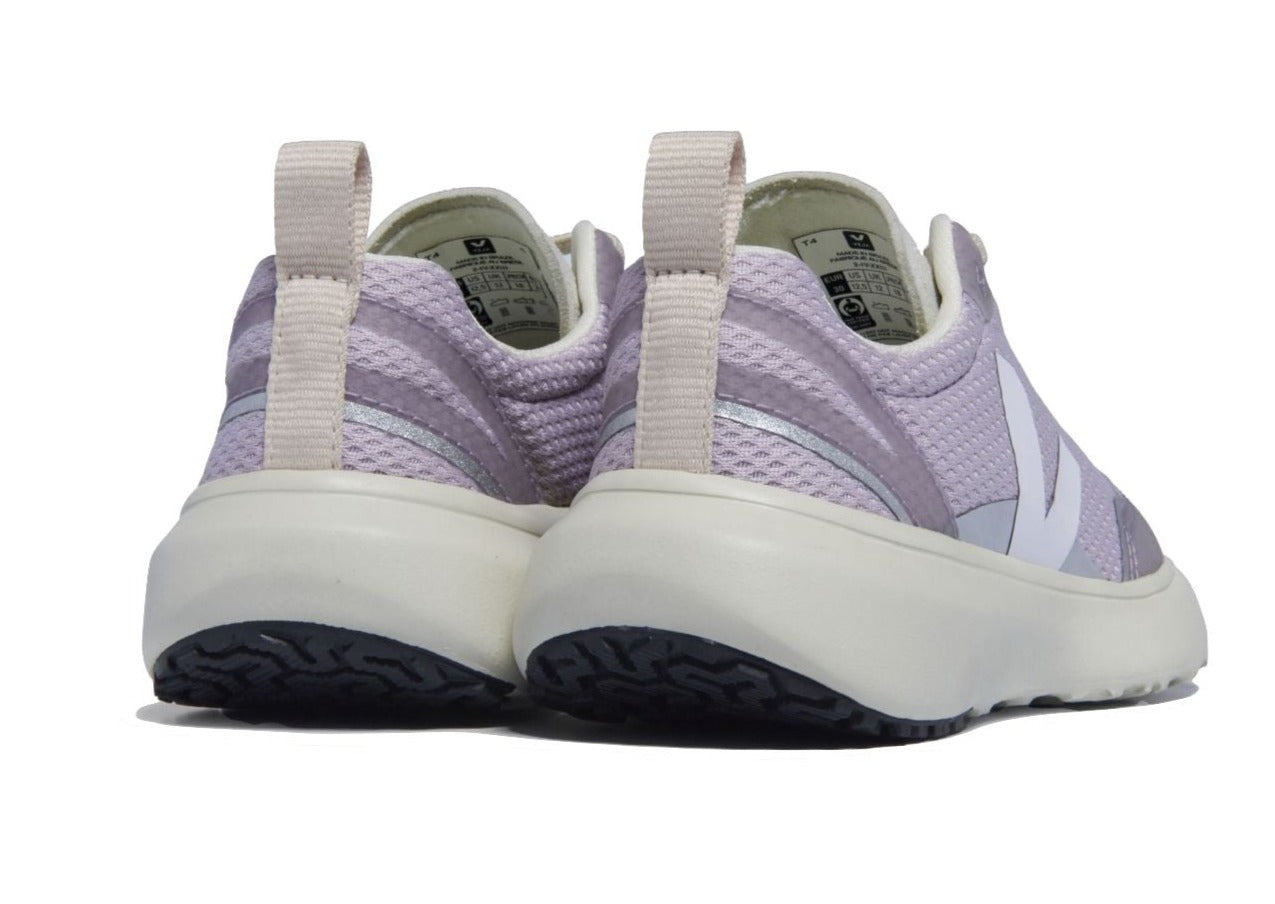 Rear view of a pair of Veja Junior Canary Alveomesh Sneakers by Veja, featuring light purple and white slip-on design with a thick white sole crafted from Amazonian rubber and pull tabs on the heel.