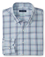 Folded blue and white plaid button-down shirt with the "Peter Millar" brand label visible at the collar. The Peter Millar Caspian Cotton Sport Shirt is crafted from refined cotton and features a Flex Finish for added comfort and movement.