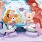 Two Calico Critters Baby Mermaid figures sit on purple seats in the Baby Mermaid Castle playset, featuring an underwater theme with bubbles and pastel decorations.
