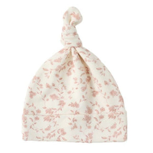 The Quincy Mae Knotted Baby Hat features a cream color with a pink floral pattern, made from soft brushed jersey.