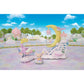 A pastel toy scene from the Calico Critters Daydream Parade Playset features a small animal figure, a yellow crescent moon with clouds, a whimsical pink steam train, and enchanting scenery under a blue sky with clouds.