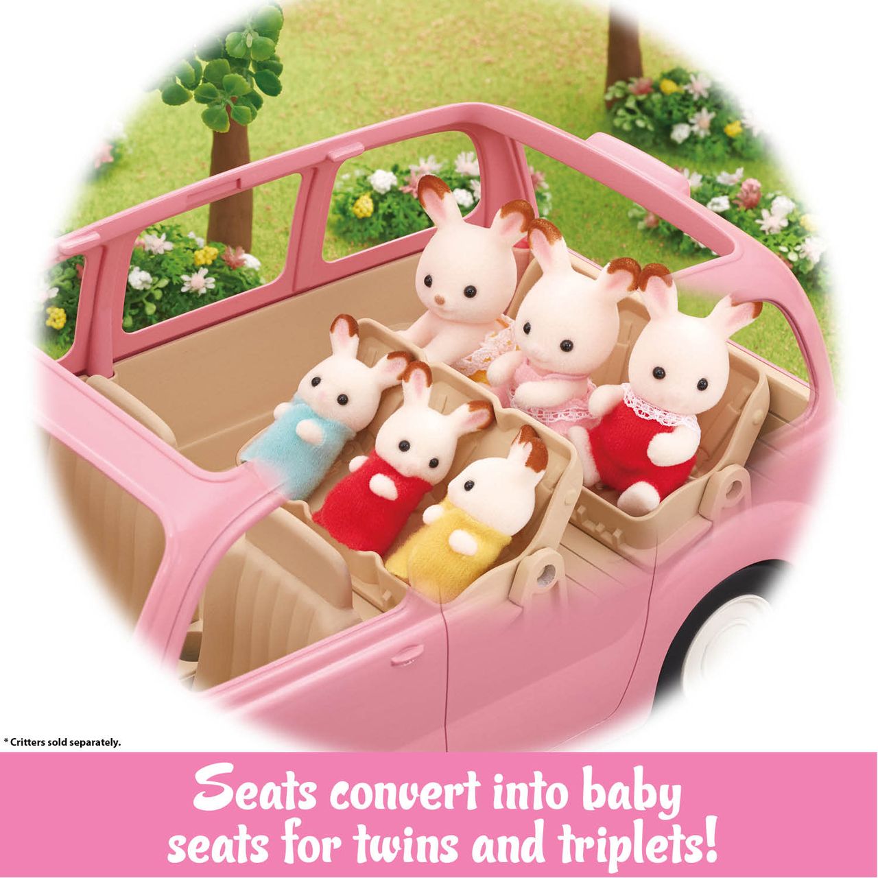 Four small Calico Critters animal figures sit in the pink Calico Critters Family Picnic Van with adjustable baby seats, surrounded by grass and flowers and ready for a fun-filled day with their included picnic accessories.