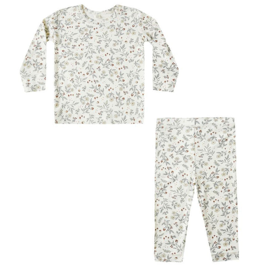 The Quincy Mae Baby Girls' and Girls' Bamboo Pajama Set is a two-piece slim-fit outfit with long sleeves and pants, featuring a white background with subtle green and red floral prints.