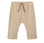 The Cozmo Baby Zach Knit Pants in beige feature an elastic waistband with a drawstring, rolled cuffs, and charming wood button accents, displayed flat on a white background.