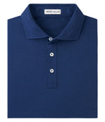 The Crown Comfort Polo by Peter Millar is a dark blue polo shirt made from soft, durable pima cotton, featuring a collar and three buttons.