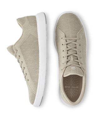 The Peter Millar Drift V2 Sneakers in beige, featuring white soles, provide flexible comfort and a true-to-size fit. They are depicted from both side and top views.