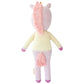 Zoe the Unicorn - Regular 20" by Cuddle + Kind is a magical knitted plush with a pink mane and tail, cream-colored body, and purple hooves, pictured from behind as if journeying into a mystical forest.